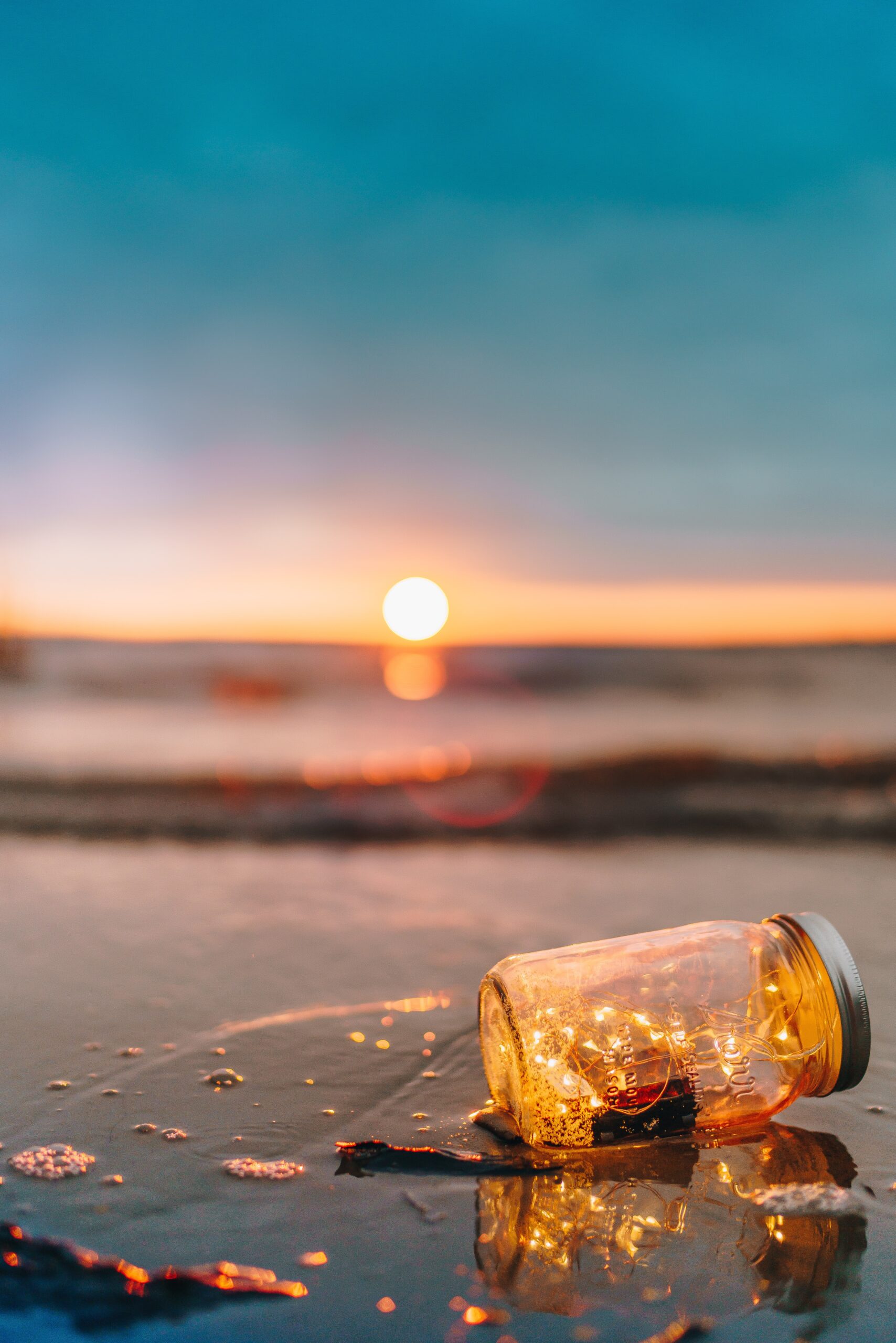 Decorative Image. Fireflies/Lights in a jar at the beach.